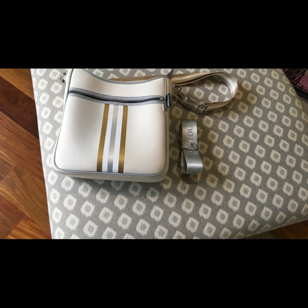 Prenelove powder neoprene messenger bag with two straps.
